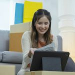 E-Commerce Entrepreneur: Young Woman Sells Clothes with Tablet