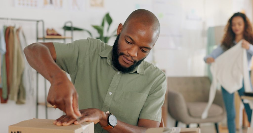 Startup business, delivery box and man doing clothes package for export, retail and ecommerce shipp