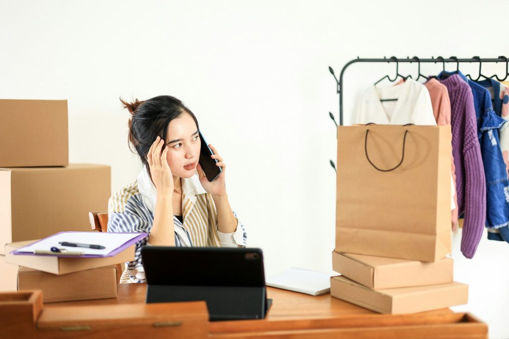 Thoughtfull Asian Female Online Shop Bussiness Owner Busy on Phone