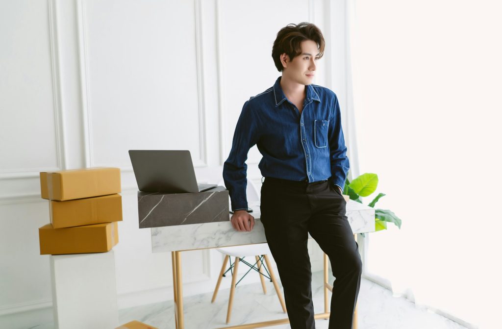 Asian entrepreneur working for omnichannel marketing commerce online and look away