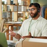 Man, call center and talking on laptop for delivery, cargo or track shipping on online shopping hel