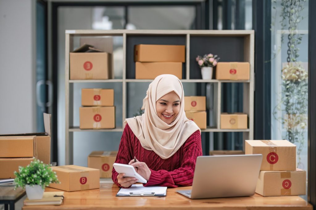Muslim Woman online store small business owner seller entrepreneur packing package post shipping box