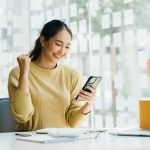 Portrait young attractive asia female owner startup business work happy with box at home prepare