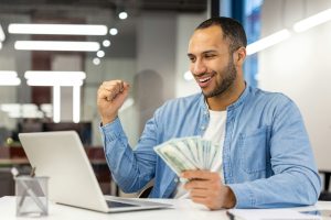 Successful businessman enjoying financial victory at the office