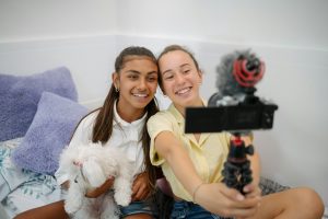 Teenage girlfriends taking selfie on camera