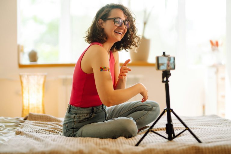 Woman blogger videotapes her vlog at home and speaking about Vaccine for covid-19.