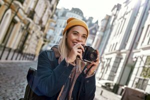 Young tourist blogger is walking with camera in old city