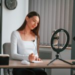 Online education. Young beautiful woman in white clothes is in the office