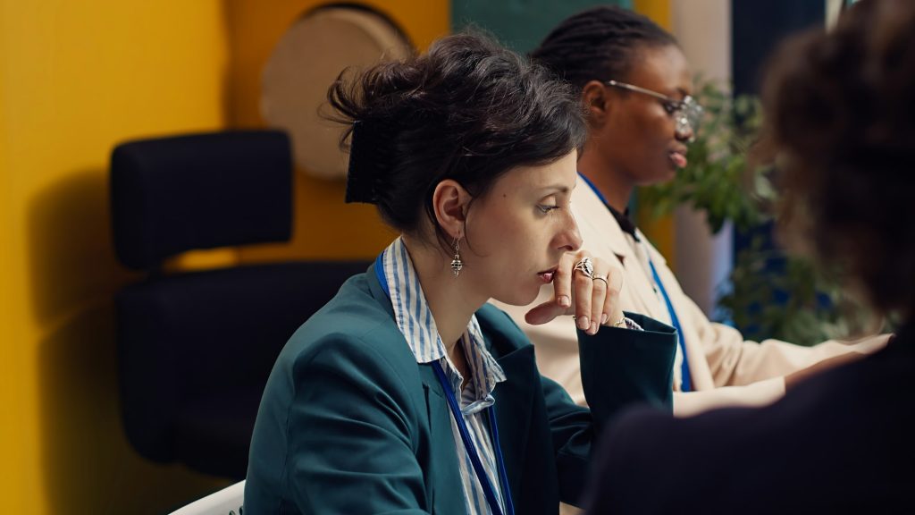 Tired overworked employee deciding to quit his job during important meeting
