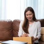 Asian female online store small business owner entrepreneur seller packing shipping ecommerce box