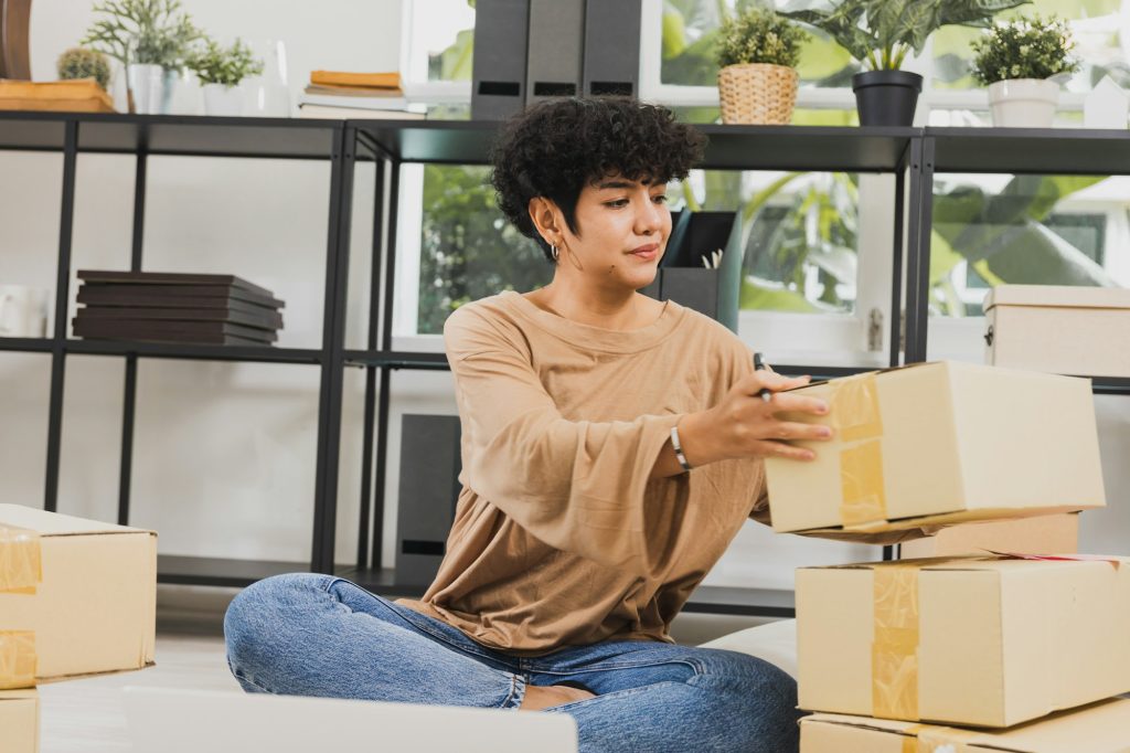 Asian woman check order on parcel and sell online