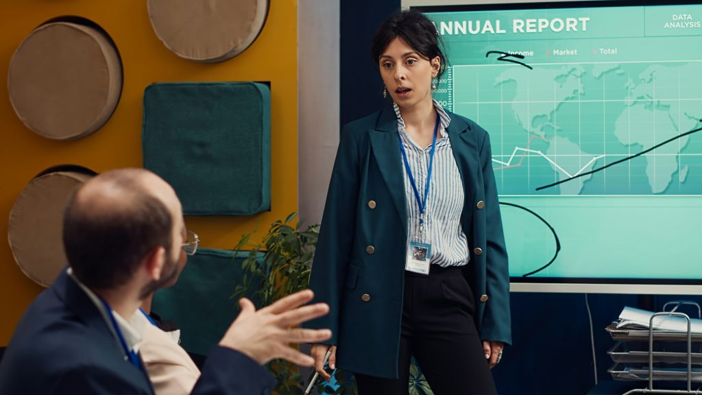 Business affiliates reviewing annual infographics reports in corporate briefing