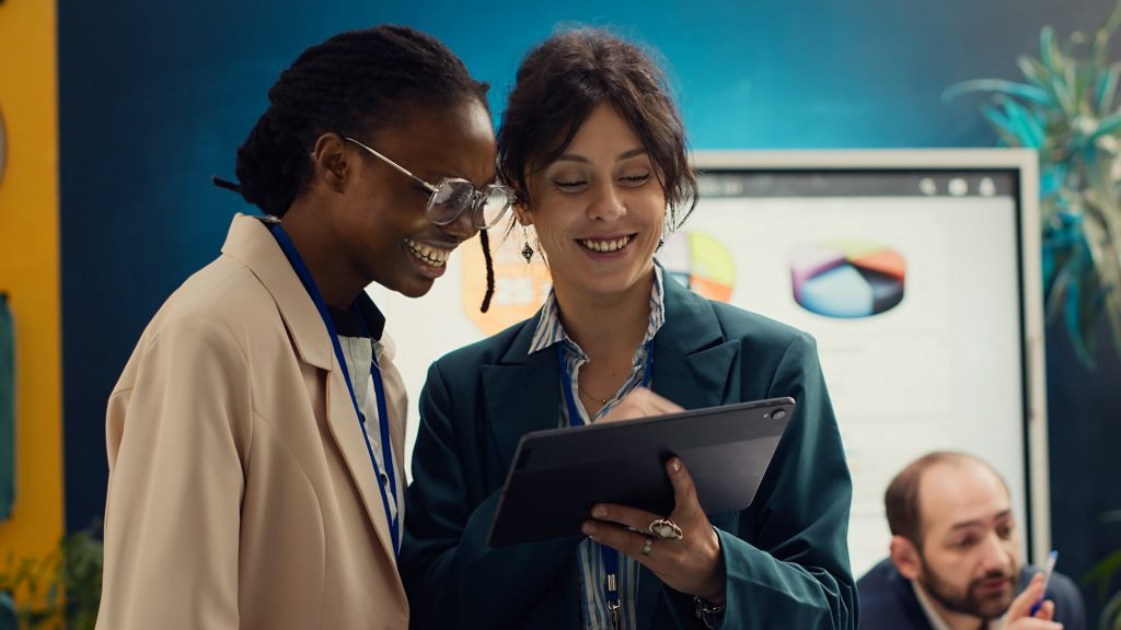 Corporate workers looking into project updates and timelines in boardroom
