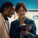 Corporate workers looking into project updates and timelines in boardroom