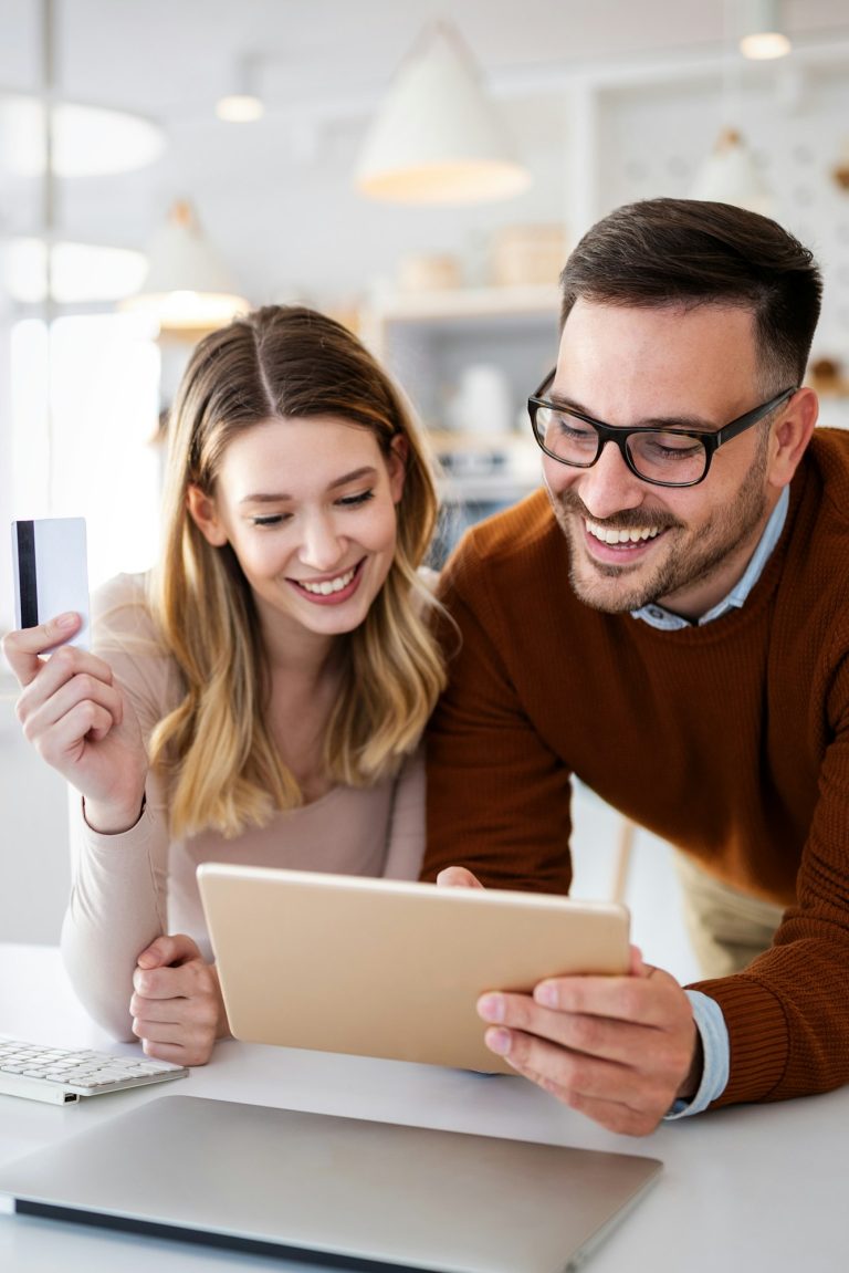 Happy smiling couple shopping online at home. Technology, e-commerce concept