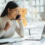 Portrait young attractive asia female owner startup business look at camera work happy with box at