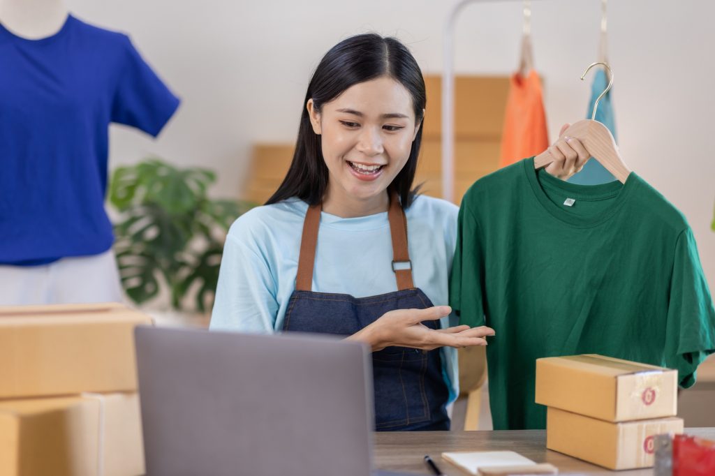 Portrait young attractive hipster asia female owner startup work happy with box at home prepare parc