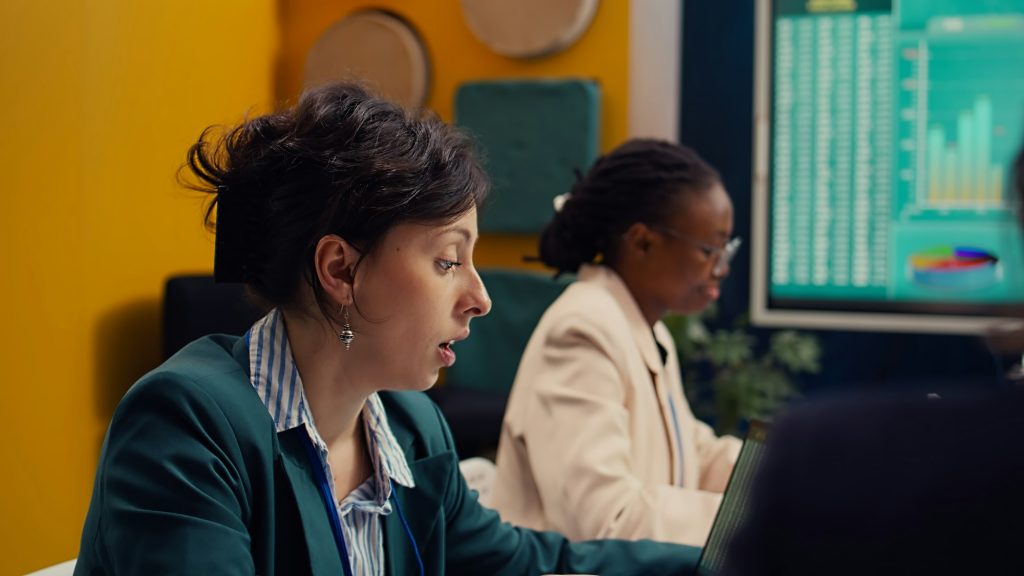 Startup team review financial reports and performance metrics on laptop