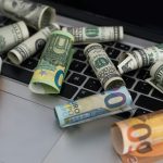 US dollars in closeup on laptop.