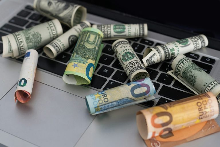 US dollars in closeup on laptop.