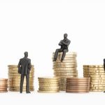 Wealth, richness, making money concept. Businessman Figurines and piles of money.